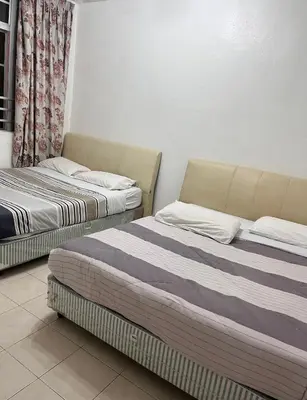 two beds sitting next to each other in a room at Cameron Crown Imperial Court @ Brinchang in Brinchang