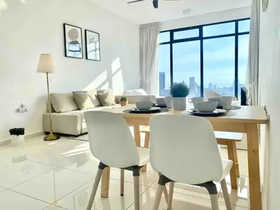 a living room with a table and chairs and a couch at Beacon Executive Suites #Warmth #SkyPool #Georgetown #5pax #2BR 2bath #2Queen 1Single #Quality well maintained #Private host in George Town