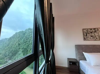 a room with a window with a view of a mountain at Ojies Onsen - 3 guest only in Ipoh