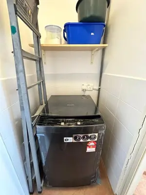 a stove in a small kitchen with a shelf at Popus Heritage Townhouse, Georgetown in George Town