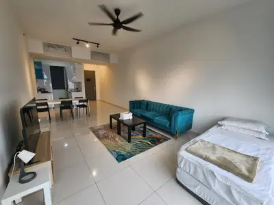 a living room with a blue couch and a table at Beacon Executive Suites - Penang in George Town