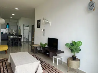 a living room with a table and a tv on a wall at Ammara homestay @ Palas Horizon kea Farm in Brinchang
