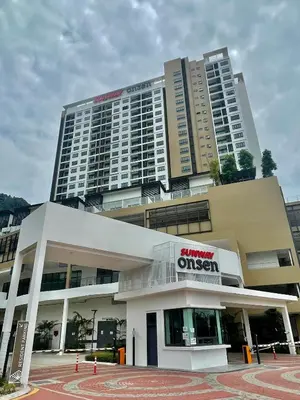 a large apartment building with a sign in front of it at Onsen Suits HJM @ Sunway Ipoh in Ipoh