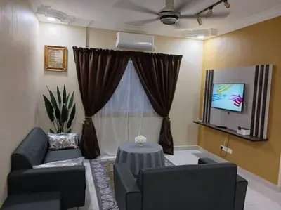 a living room with a couch and a table and a tv at My Chillex Homestay#Muslim Guest Only#3R 2B Apartment in Penang# in George Town