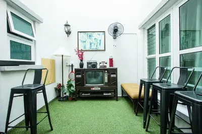 a living room with black chairs and a television at Nautilus Bay Home Inn in George Town