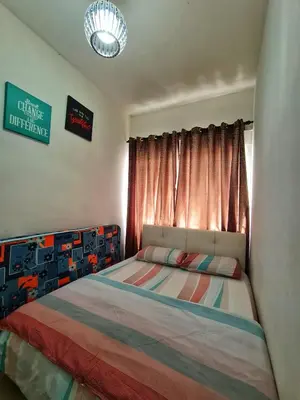 a bedroom with a bed with a colorful blanket at Amrich Staycation Muslim Cameron Highlands in Tanah Rata