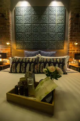 a bedroom with a bed with a tray with flowers on it at Carrot Seed in Ipoh