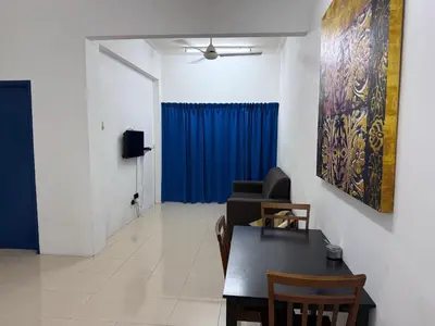 a living room with a table and a blue curtain at Homestay Lumut Perak 2026 in Lumut