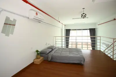 a bedroom with a bed and a balcony at Private 100 inches Screen Cinema at CEO Penang in Bayan Lepas