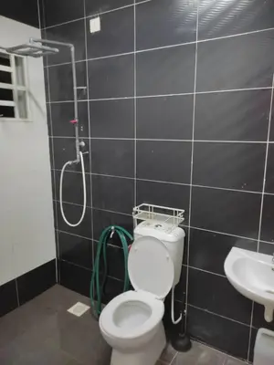 a bathroom with a shower and a toilet and a sink at Homestay Hafiy Manjung Lekir Sitiawan in Lekir