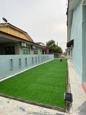 a large artificial lawn in front of a building at Nur Kasih Homestay Seri Manjung in Seri Manjung