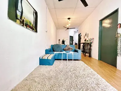 a living room with a blue couch and a rug at Cozy18#4pax#NearAeonAlma,Mcd#2kmtoIconic in Bukit Mertajam