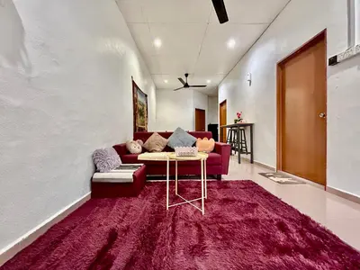 a living room with a couch and a table at Cozy255#4pax#Wifi#NearAeonAlma#5kmtoIconCity in Bukit Mertajam