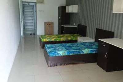 a room with two beds in a room with a counter at Studio House Kampar in Kampar