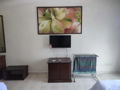 a living room with a tv on a wall at Sofea Inn Bukit Merah - Suria A7727 in Kampong Selemat