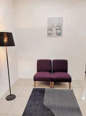 a purple chair in a room with a lamp and a rug at Botani Tmn Cyber Ipoh(24 pax /tv box/mahjong) in Ipoh
