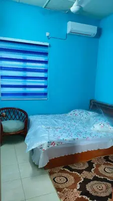 a blue room with a bed and a chair at Che Det Homestay Chemor in Chemor