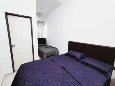 a bedroom with a purple bed and a chair at Bdr Seri Botani ipoh-nordic (tvbox/mahjong 19pax) in Ipoh