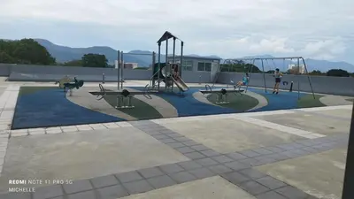 a playground with children playing on a swing set at Spaces 3bed Room New Condo @ Kg Paloh Ipoh in Ipoh
