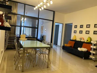 a living room with a table and a couch at Paddy Bee in Brinchang