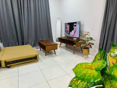 a living room with a tv and a piano at The Sun 1 or 3BR Bayan Lepas 4 to 10 pax WL in Bayan Lepas