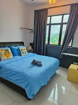 a bedroom with a bed with blue sheets and windows at The Sun 1 or 3BR Bayan Lepas 4 to 10 pax WL in Bayan Lepas