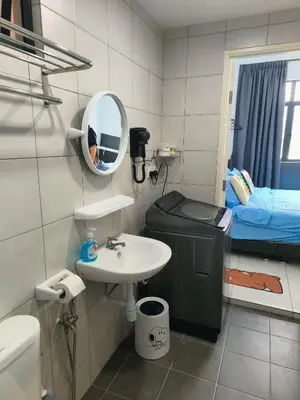 a bathroom with a sink and a mirror and a bed at The Sun 1 or 3BR Bayan Lepas 4 to 10 pax WL in Bayan Lepas