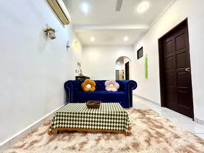 a living room with a blue couch and a rug at Cozy14#4pax#Wifi#NearAeonAlma#5kmtoIconCity in Bukit Mertajam