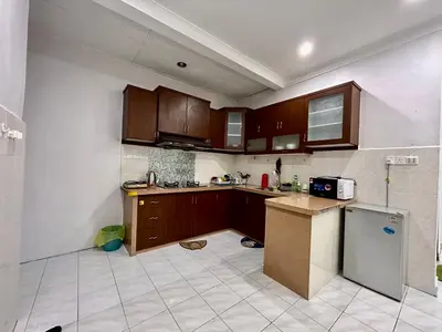 a kitchen with wooden cabinets and a tile floor at Cozy14#4pax#Wifi#NearAeonAlma#5kmtoIconCity in Bukit Mertajam