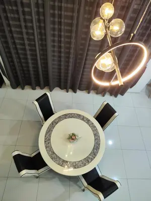 a table with chairs and a chandelier in a room at Ipoh Lake View Cozy Home Big House in Lahat