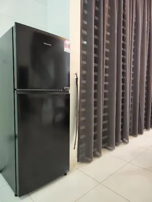 a black refrigerator next to a row of curtains at Ipoh Lake View Cozy Home Big House in Lahat