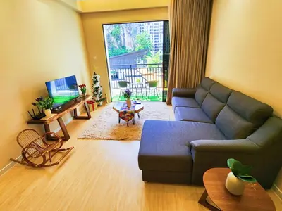a living room with a blue couch and a table at The Cove Ipoh Garden East, Taman Ipoh Permai, Garden East, 31400 IPOH in Ipoh