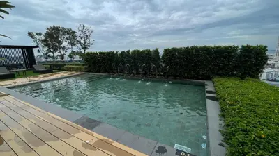 a swimming pool in a yard with a wooden deck at Beacon Executive Suites #Georgetown #RoofTopPool #10 in George Town