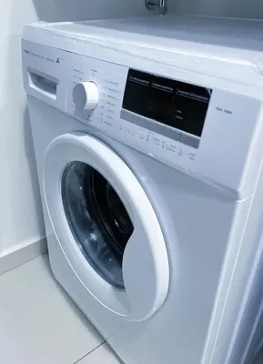 a white washing machine sitting in a room at Beacon Executive Suites #Georgetown #RoofTopPool #10 in George Town