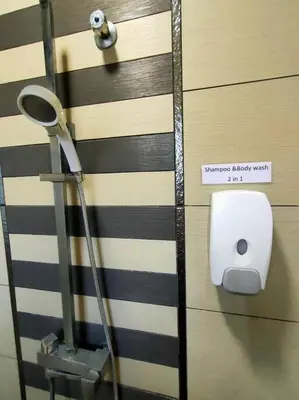 a bathroom door with a mirror and a towel dispenser at 678 homestay 4 room 5 minutes to tower in Teluk Intan