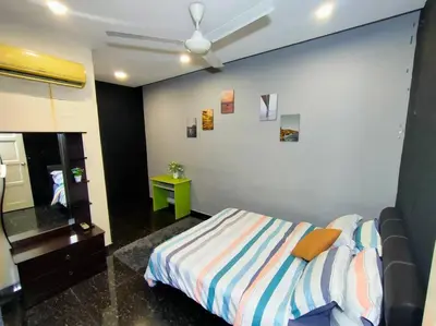 a bedroom with a bed and a ceiling fan at 678 homestay 4 room 5 minutes to tower in Teluk Intan