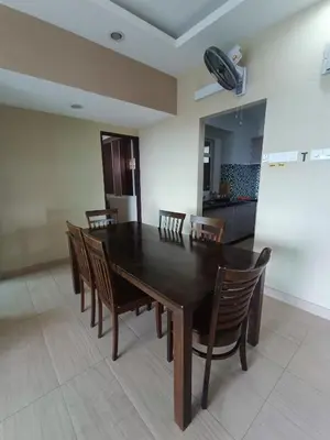 a dining room with a wooden table and chairs at Lovers Island homestay in Batu Ferringhi