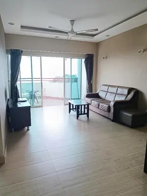 a living room with a couch and a table at Lovers Island homestay in Batu Ferringhi