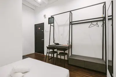 a bedroom with a bed and a desk in it at Kangsar Inn 73 in George Town