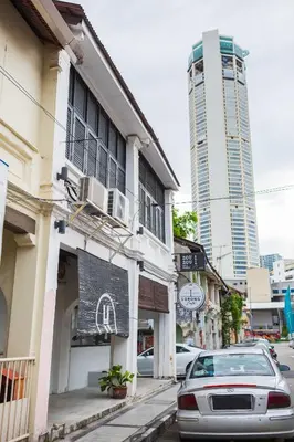 a street with buildings and a car parked on the street at Kangsar Inn 73 in George Town