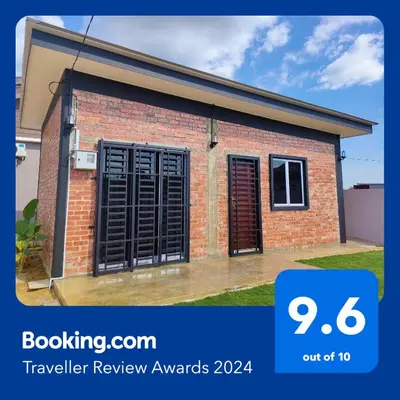 a small brick house with black window shutters at Studio Amani 1 Permatang Pauh in Permatang Pauh