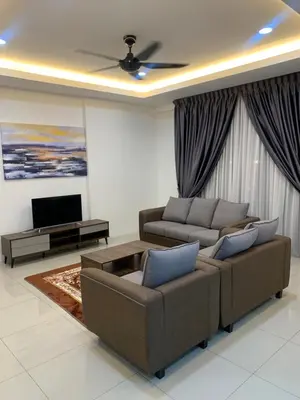 a living room with two couches and a tv at SM Homestay @ Meru Casa Kayangan in Ipoh