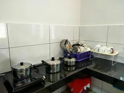 a kitchen with three pots and pans on a stove at AVENUE HOMESTAY 5 Room 4 Toilet 4 MINUTES TO TOWER in Teluk Intan