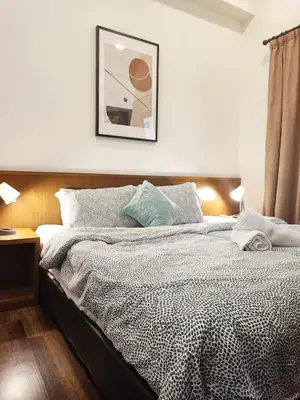 a bedroom with a bed and a picture on the wall at Muji Homestay @ The Retreat, Cameron Highlands in Cameron Highlands