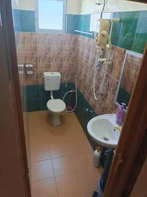 a bathroom with a toilet and a sink at Hotel Langkap LW \u51b7\u7532\u9152\u5e97 in Kampung Degong