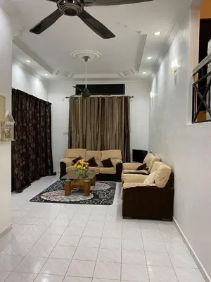 a living room with two couches and a ceiling fan at AlFarizqi Muslim Residence SP in Sungai Petani