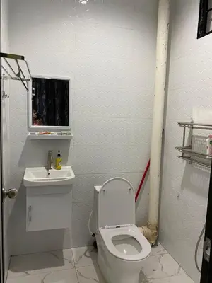 a bathroom with a white toilet and a sink at AlFarizqi Muslim Residence SP in Sungai Petani