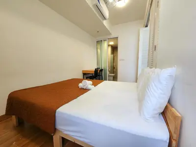 a bedroom with a bed with a teddy bear on it at The MINDI, 2BR Cityview by WStay @ Tropicana 218 Macalister in George Town