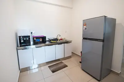a kitchen with a stainless steel refrigerator at De Luma-Metropol in Bukit Mertajam