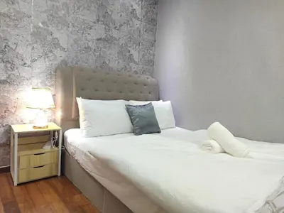 a bedroom with two beds and a lamp on a night stand at Gurney Duplex / 2bedrooms / 8pax in George Town